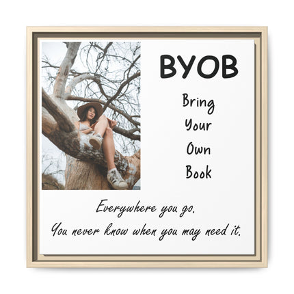 Framed matte canvas featuring a soft, candid photograph of a reader perched in a tree with “BYOB: Bring Your Own Book” text