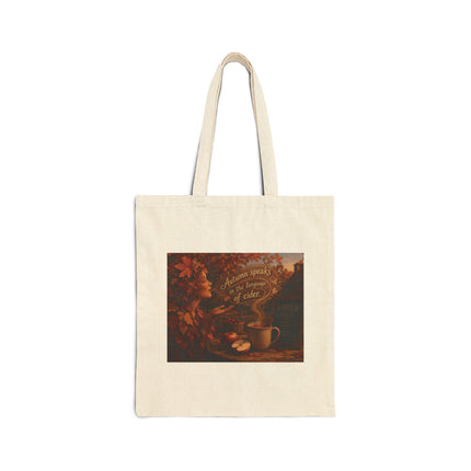 Canvas tote bag with AI image of a mug of cider, an autumn spirit, and text "Autumn speaks in the language of cider"