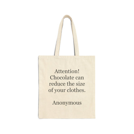 Cotton canvas tote bag with the humorous quote “Attention! Chocolate can reduce the size of your clothes” printed on the front