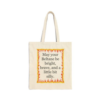 Natural cotton canvas tote featuring a warm hand‑drawn flame border and the Beltane blessing “May your Beltane be bright, brave, and a little bit silly”