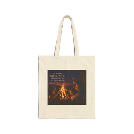 Cotton canvas tote featuring a warm, earthy illustration of a woman tending a small Imbolc bonfire with glowing embers